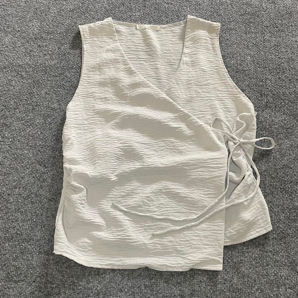 Office siren minimalist neutral light gray Zara sleeveless wrap top